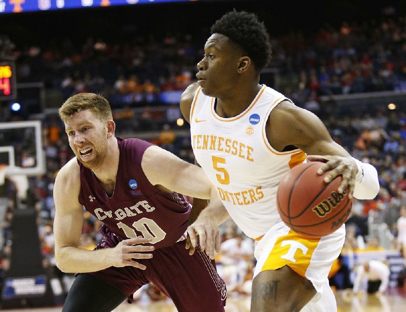 Tennessee’s Admiral Schofield drives past Colgate’s Will Rayman in the first half of a South Region first-round game in the NCAA Tournament on Friday in Columbus, Ohio. Schofield had 19 points as the Vols won 77-70.