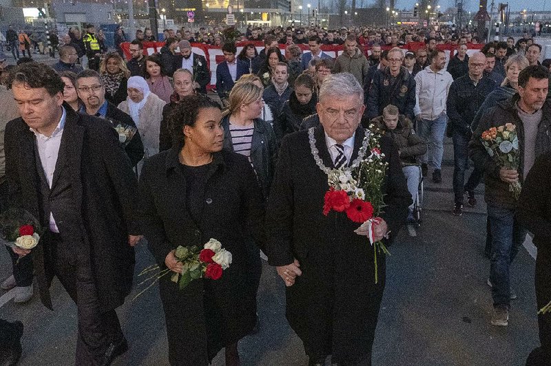 Jan van Zanen, (center) mayor of the Dutch town of Utrecht, walks Friday with mourners heading to the scene of Monday’s deadly tram attack.