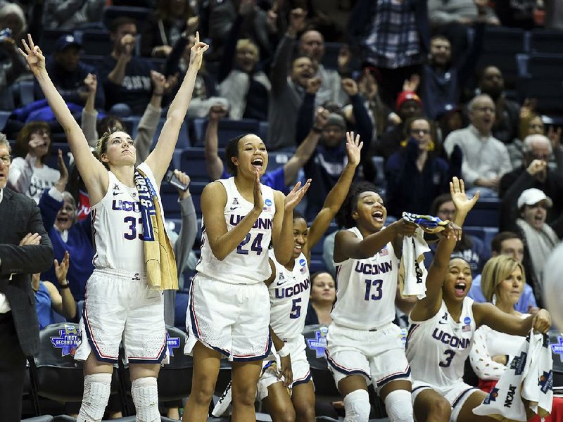 Connecticut’s Katie Lou Samuelson (33) and the rest of the team’s starters cheer from the bench in the closing seconds of the Huskies’ 110-61 victory over Towson on Friday.