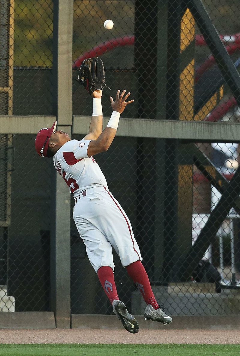 Arkansas left fielder Christian Franklin makes a leaping catch on the warning track Friday during the third inning of the Razorbacks’ 12-3 victory over the Alabama Crimson Tide at Sewell-Thomas Stadium in Tuscaloosa, Ala.