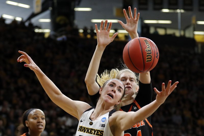 The Associated Press FORWARD FIGHTS: Iowa forward Hannah Stewart, front, fights for a rebound with Mercer center Rachel Selph during a first-round game in the NCAA women's college basketball tournament, Friday in Iowa City, Iowa. Iowa won 66-61.