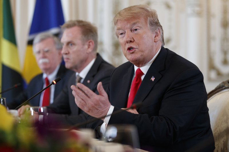 From left, National Security Adviser John Bolton, Acting Defense Secretary Patrick Shanahan, and President Donald Trump sit together during a meeting with Caribbean leaders at Mar-A Lago, Friday, March 22, 2019, in Palm Beach, Fla. (AP Photo/Carolyn Kaster)