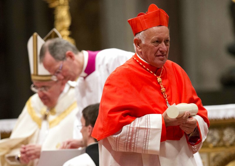 In this Saturday, Feb.22, 2014 file photo, newly-elected Cardinal Ricardo Ezzati Andrello, Archbishop of Santiago, Chile, holds his papal Bull of the Creation of Cardinals and wears the red three-cornered biretta hat during a consistory inside the St. Peter's Basilica at the Vatican. Pope Francis has replaced Cardinal Ricardo Ezzati, the embattled archbishop of Santiago, Chile, after he became embroiled in the country's spiraling sex abuse and cover-up scandal. Francis on Saturday, March 23, 2019, accepted Ezzati's resignation and named a temporary replacement to govern Chile's most important archdiocese: the current bishop of Copiapo, Monsignor Celestino Aos Braco. (AP Photo/Alessandra Tarantino, File)
