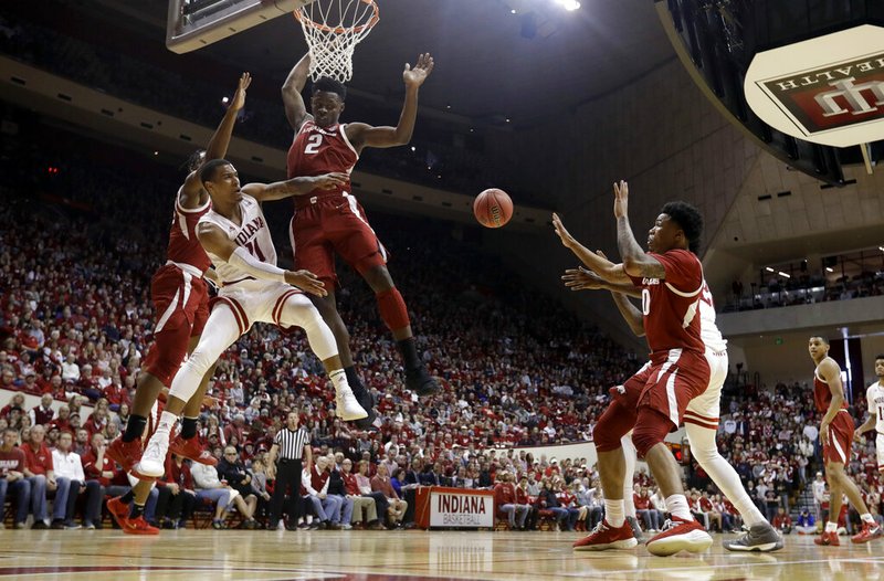 Indiana's Devonte Green (11) makes a pass against Arkansas's Adrio Bailey (2) during the second half in the second round of the NIT college basketball tournament, Saturday, March 23, 2019, in Bloomington, Ind. Indiana won 63-60. (AP Photo/Darron Cummings)