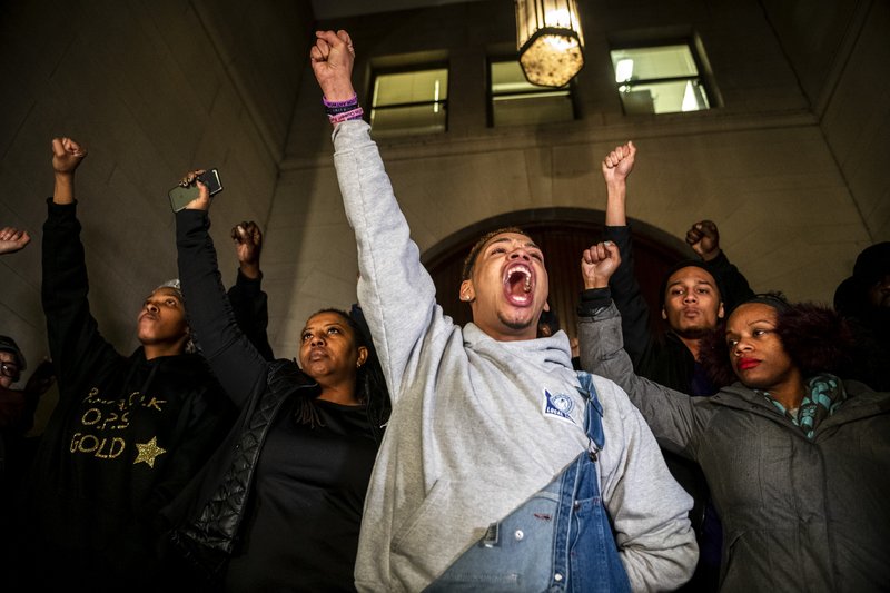 Christian Carter (left) leads a chant with other supporters of Antwon Rose II after they learned of a not guilty verdict in the homicide trial of former East Pittsburgh police officer Michael Rosfeld, Friday, March 22, 2019, at the Allegheny County Courthouse in downtown Pittsburgh, Pa. (Michael M. Santiago/Pittsburgh Post-Gazette via AP)