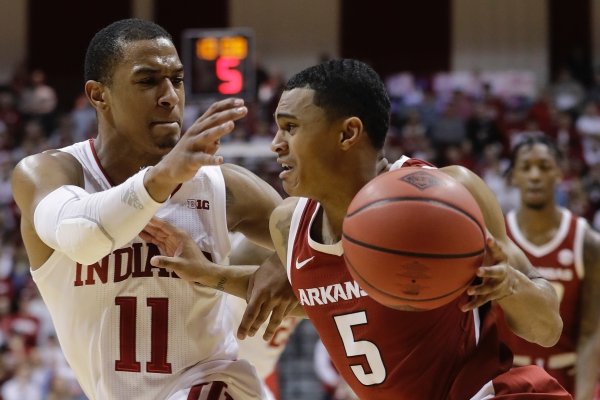 Arkansas's Jalen Harris (5) goes to the basket against Indiana's Devonte Green (11) during the first half in the second round of the NIT college basketball tournament, Saturday, March 23, 2019, in Bloomington, Ind. (AP Photo/Darron Cummings)