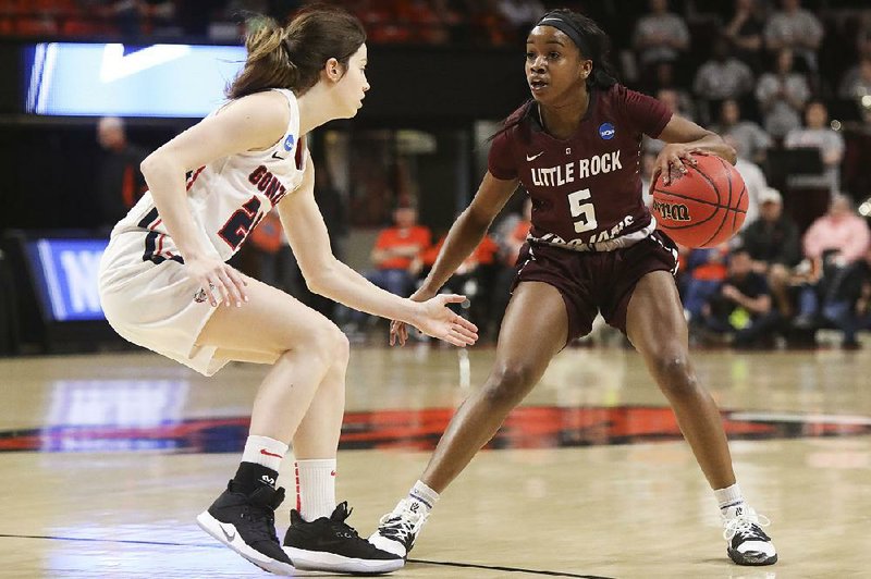 UALR’s Tori Lasker (5) dribbles against Gonzaga’s Katie Campbell during the Trojans’ loss to the Bulldogs on Saturday in an NCAA Women’s Tournament first-round game at Gill Coliseum in Corvallis, Ore. UALR ended its season at 21-11. 