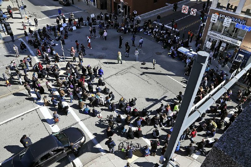 Marchers block an intersection Saturday near the PPG Paints Arena in downtown Pittsburgh during a protest against the acquittal of former East Pittsburgh police officer Michael Rosfeld. 