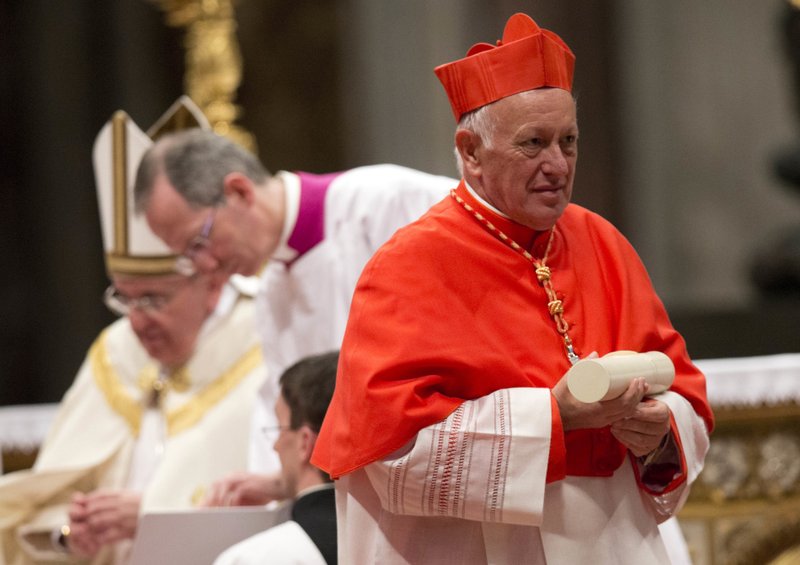 In this Saturday, Feb. 22, 2014 file photo, newly-elected Cardinal Ricardo Ezzati Andrello, Archbishop of Santiago, Chile, holds his papal Bull of the Creation of Cardinals and wears the red three-cornered biretta hat during a consistory inside the St. Peter's Basilica at the Vatican. Pope Francis has replaced Cardinal Ricardo Ezzati, the embattled archbishop of Santiago, Chile, after he became embroiled in the country's spiraling sex abuse and cover-up scandal. Francis on Saturday, March 23, 2019, accepted Ezzati's resignation and named a temporary replacement to govern Chile's most important archdiocese: the current bishop of Copiapo, Monsignor Celestino Aos Braco. (AP Photo/Alessandra Tarantino, File)