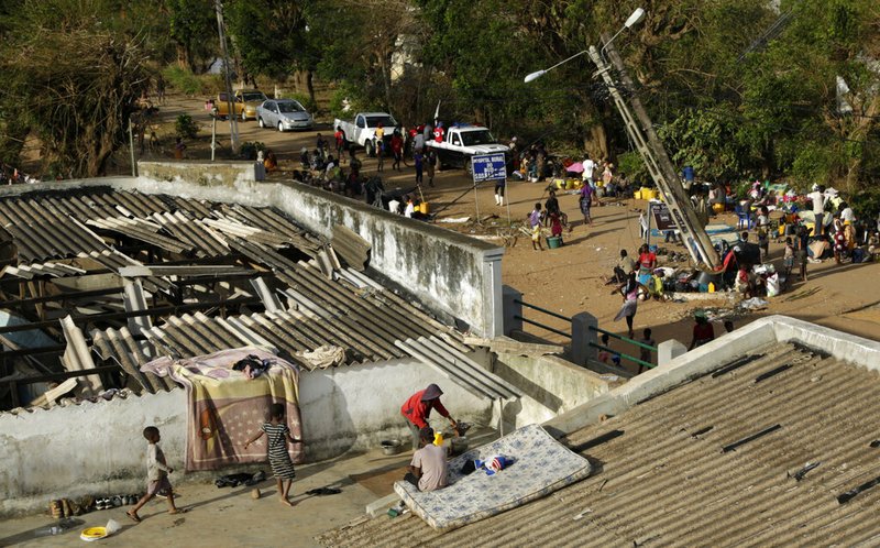 Displaced families set up their bedding on top of the roof in Buzi district, 200 kilometers (120 miles) outside Beira, Mozambique, on Saturday, March 23, 2019. A second week has begun with efforts to find and help some tens of thousands of people in devastated parts of southern Africa, with some hundreds dead and an unknown number of people still missing. (AP Photo/Themba Hadebe)