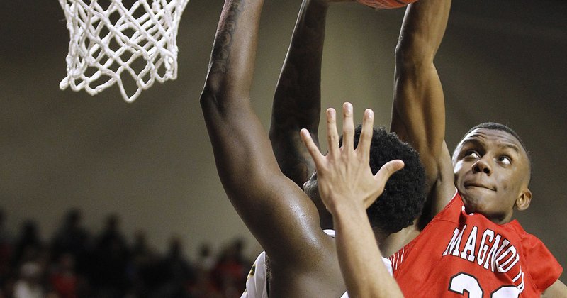 Magnolia’s Derrian Ford (right) blocks the final shot of Mills’ Kevin Cross (23) during overtime of the Panthers' 78-76 win over Mills in the Class 4A boys basketball state championship on Saturday, March 9, 2019, at  Bank OZK Arena in Hot Springs. 