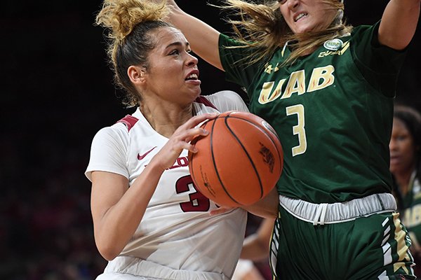Arkansas' Chelsea Dungee drives to the basket while UAB's Angela Vendrell defends during a WNIT game Sunday, March 24, 2019, at Bud Walton Arena in Fayetteville.