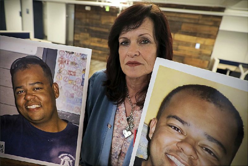 Sabine Durden of Mineral Springs holds photos of her son Dominic, who was killed by a driver in the country illegally. Durden attended a White House ceremony in which President Donald Trump vetoed a measure to overturn his border emergency declaration. 
