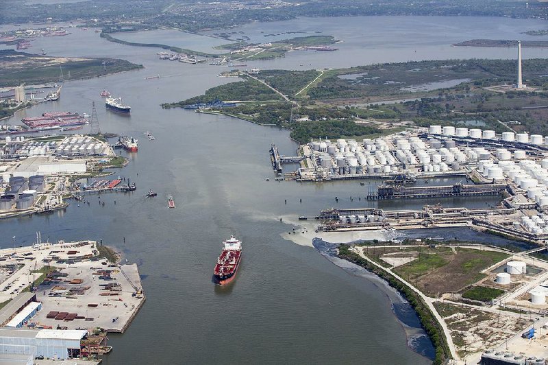 Maritime traffic moves through the Houston Ship Chanel past the site of now-extinguished petrochemical tank fire at Intercontinental Terminals Company in Deer Park, Texas, last week. 