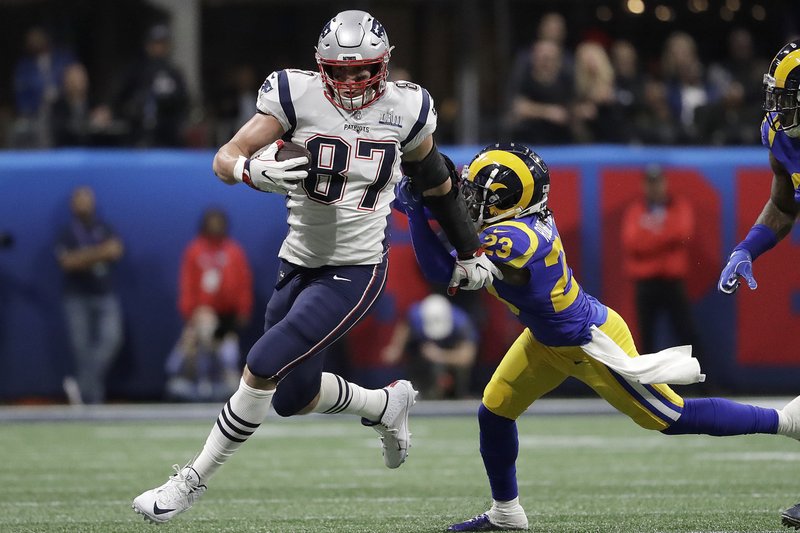 The Associated Press BIG SMILE: In this Feb. 3 file photo, New England Patriots' Rob Gronkowski (87) runs against Los Angeles Rams' Nickell Robey-Coleman (23) during the first half of the NFL Super Bowl 53 football game in Atlanta. Gronkowski says he is retiring from the NFL after nine seasons. Gronkowski announced his decision via a post on Instagram Sunday, saying that a few months shy of this 30th birthday "its time to move forward and move forward with a big smile."