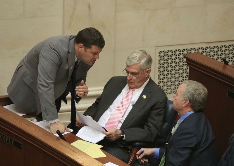 Sens. Bart Hester (from left), Bill Sample and Keith Ingram confer Monday on the Senate floor before Hester presents his tax legislation. More photos are available at arkansasonline.com/326genassembly/.