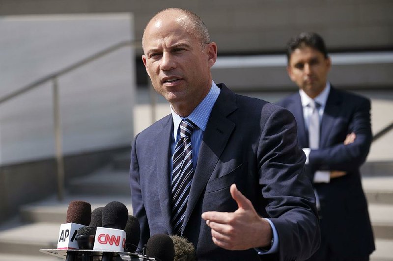 Attorney Michael Avenatti replies to questions by reporters during a news conference in front of the U.S. Federal Courthouse in Los Angeles in July.