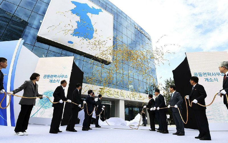 South Korea’s Unification Minister Cho Myoung-gyon (center left) and Ri Son Gwon, chairman of the North’s Committee for the Peaceful Reunification (center right) attend an opening ceremony for two Koreas’ first liaison office in Kaesong, North Korea, in September.