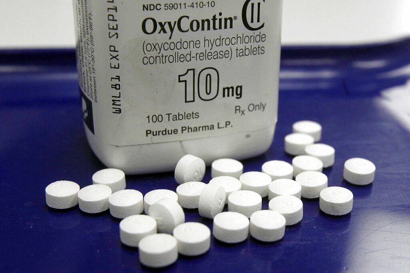 This Feb. 19, 2013, file photo shows OxyContin pills arranged for a photo at a pharmacy in Montpelier, Vt. Oklahoma's attorney general will announce a settlement Tuesday, March 26, 2019, with Purdue Pharma, one of the drug manufacturers named in a state lawsuit that accuses them of fueling the opioid epidemic. (AP Photo/Toby Talbot, File)