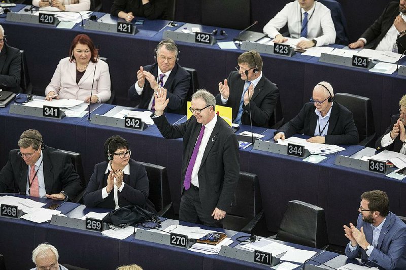 Axel Voss (standing) was lead backer of the bill, approved Tuesday by the European Parliament, designed to give musicians, authors and news publishers more copyright protection. 