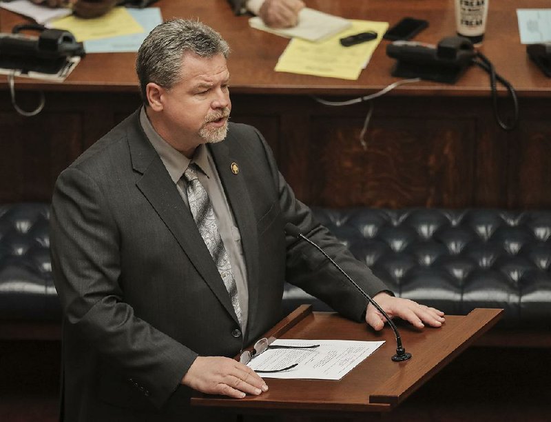 Sen. Alan Clark speaks in the Senate chamber Tuesday for his Senate Joint Resolution 15, which proposes a constitutional amendment to limit lawmakers to 12 consecutive years of service. Lawmakers could serve again after sitting out four years. More photos are available at arkansasonline.com/327genassembly/ 