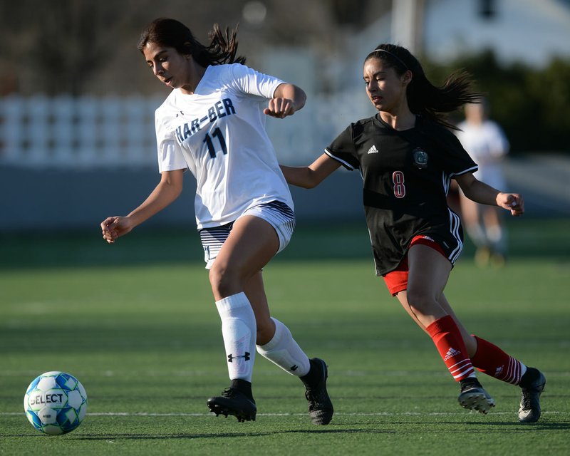NWA Democrat-Gazette/ANDY SHUPE Har-Ber's Kasandra Medina (11) and Springdale's Daniela Avila vie for the ball Tuesday, March 26, 2019, during Har-Ber's 1-0 win at Jarrell Williams Bulldog Stadium in Springdale. Visit nwadg.com/photos to see more photographs from the game.