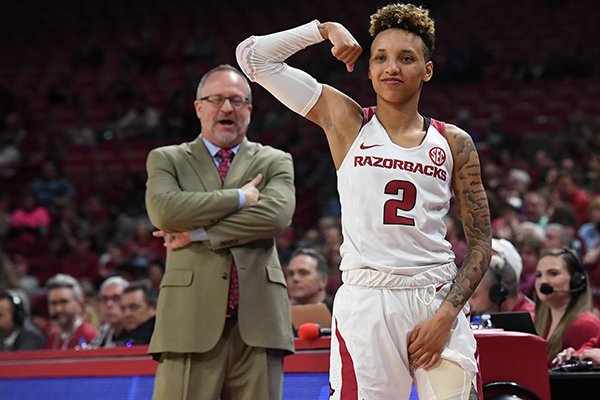 Arkansas guard Alexis Tolefree flexes while coach Mike Neighbors looks on during a second round WNIT game against UAB on Sunday, March, 24, 2019, in Fayetteville.