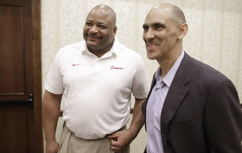 Former NFL coach Tony Dungy (right) with and former Green Bay Packer Keith Jackson in January 2013. AP photo