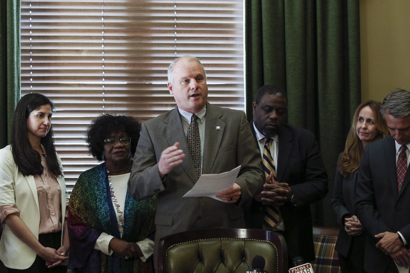 In this file photo Senate President Pro Tempore Jim Hendren (center) , R-Sulphur Springs, is shown surrounded by Democratic and Republican lawmakers at the state Capitol. 