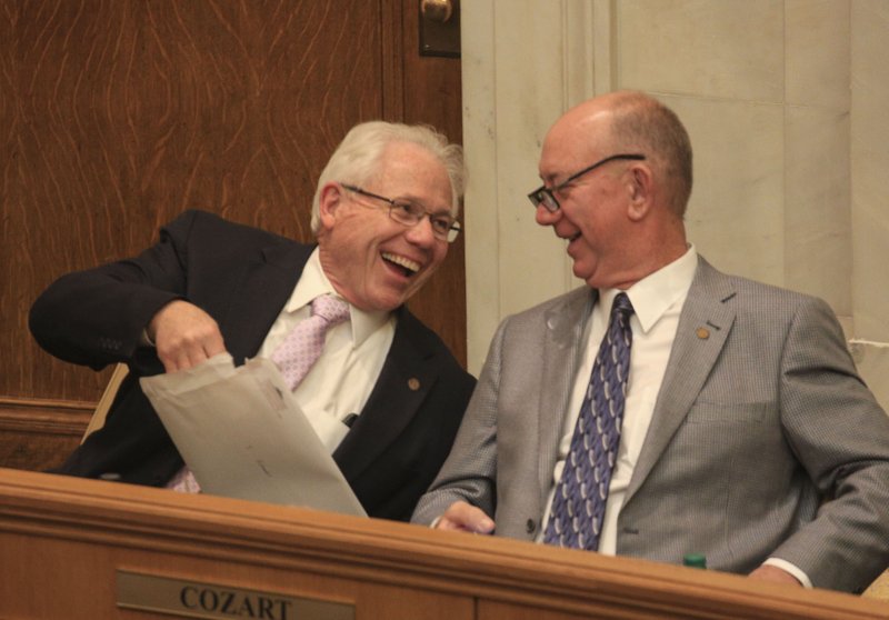 Rep. Bruce Cozart (right), R-Hot Springs, talks with Rep. Jon Eubanks, R-Paris, on the House floor.  