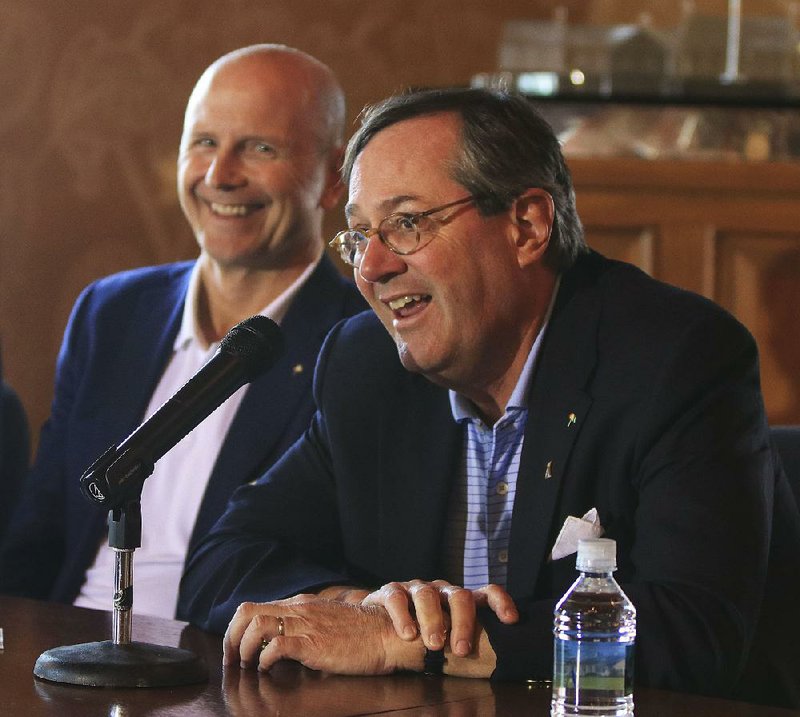 Alotian Club founder and chairman Warren Stephens (right) and Arnold Palmer Enterprises Chief Executive Officer Jon Podany answer questions Wednesday during a news conference for the Arnold Palmer Cup, which will be held June 7-9.
