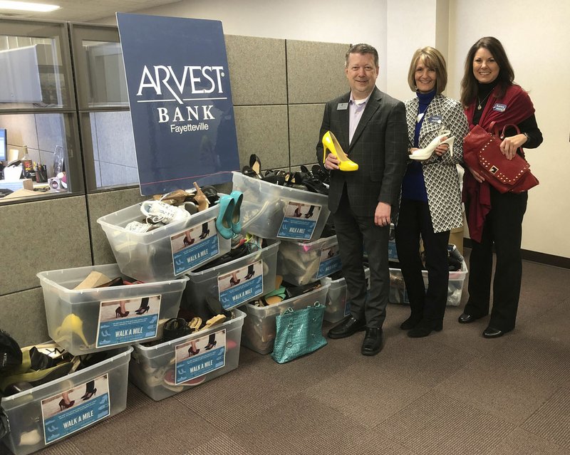 Courtesy photo Arvest Bank associates contributed more than 320 pairs of shoes to Ozark Guidance for its annual Walk a Mile in My Shoes fundraising event on April 5-6. Steven R. Hinds, vice president of philanthropy and development for Ozark Guidance, is shown with Gaye Wilcox, executive vice president/sales manager, and Karen Gray, vice president/marketing manager for Arvest Bank. The ninth annual Walk a Mile in My Shoes event includes a VIP Presale Party on April 5. Tickets are $50 and may be purchased by calling (479) 725-5294. The sale begins at 8 a.m. April 6 and is open to the public. Both events are at the Holiday Inn, 1500 S. 48th St. in Springdale.