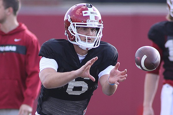 Arkansas quarterback Ben Hicks takes a snap during practice Tuesday, March 26, 2019, in Fayetteville. 