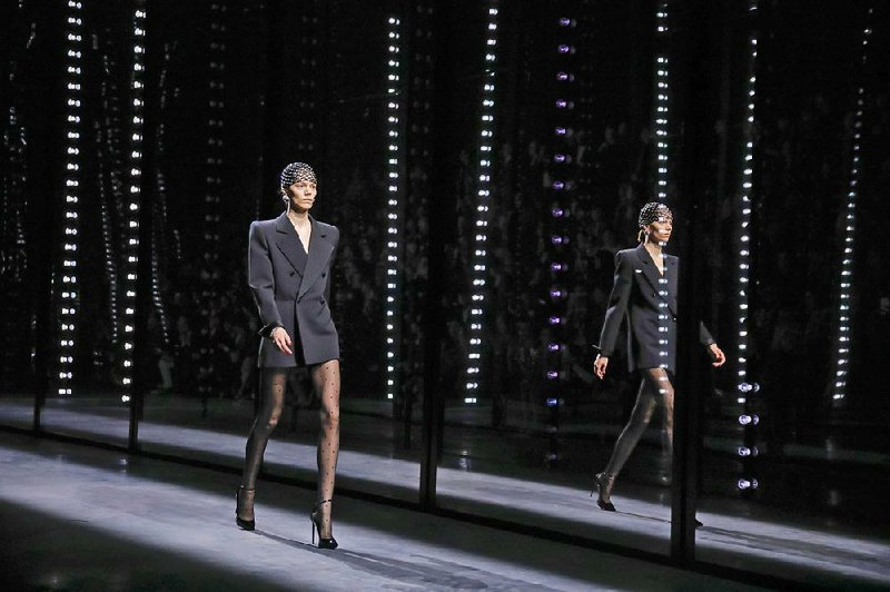 A model walks the runway at Saint Laurent Fashion show Feb. 26 in Paris. The dress codes of infl uence and authority are one big mass of confusion — just look at the Oscars and Congress, at Goldman Sachs and the recent runways. 