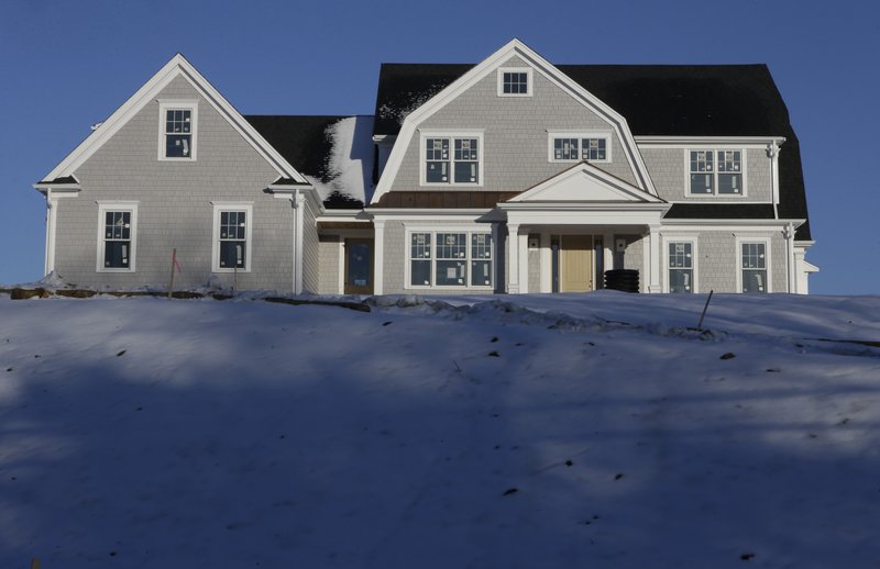 In this Thursday, Feb. 21, 2019 photo a recently constructed home is surrounded by snow in Natick, Mass. On Thursday, March 28, Freddie Mac reports on this week&#x2019;s average U.S. mortgage rates. (AP Photo/Steven Senne)