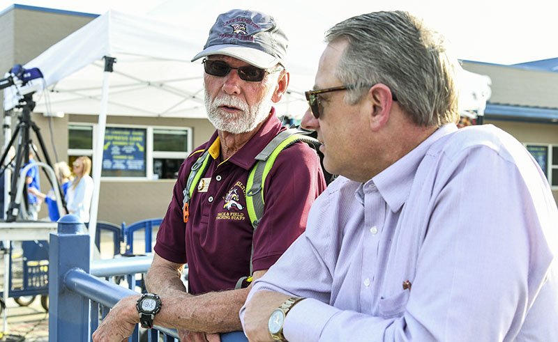 TALKING TRACK: Lake Hamilton head track and field coach Karl Koonce, left, talks with Lake Hamilton High School principal Donald Westerman Thursday at the Lakeside Ram Relays. Koonce announced Thursday that he will be retiring from coaching at the end of the year.