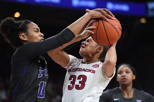 Arkansas' Chelsea Dungee has a shot blocked by TCU's Jayde Woods during a third round WNIT game Thursday, March 28, 2019, in Fayetteville.