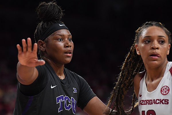 TCU's Amy Okonkwo is guarded by Arkansas' Kiara Williams during a third round WNIT game Thursday, March 28, 2019, in Fayetteville.