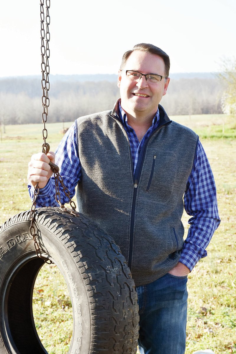 Jeremy Riddle stands by a tire swing outside his home in Greenbrier. Riddle, a businessman, was named Volunteer of the Year by the Greenbrier Chamber of Commerce. He was the impetus for character programs in the school district and is involved in several community projects.