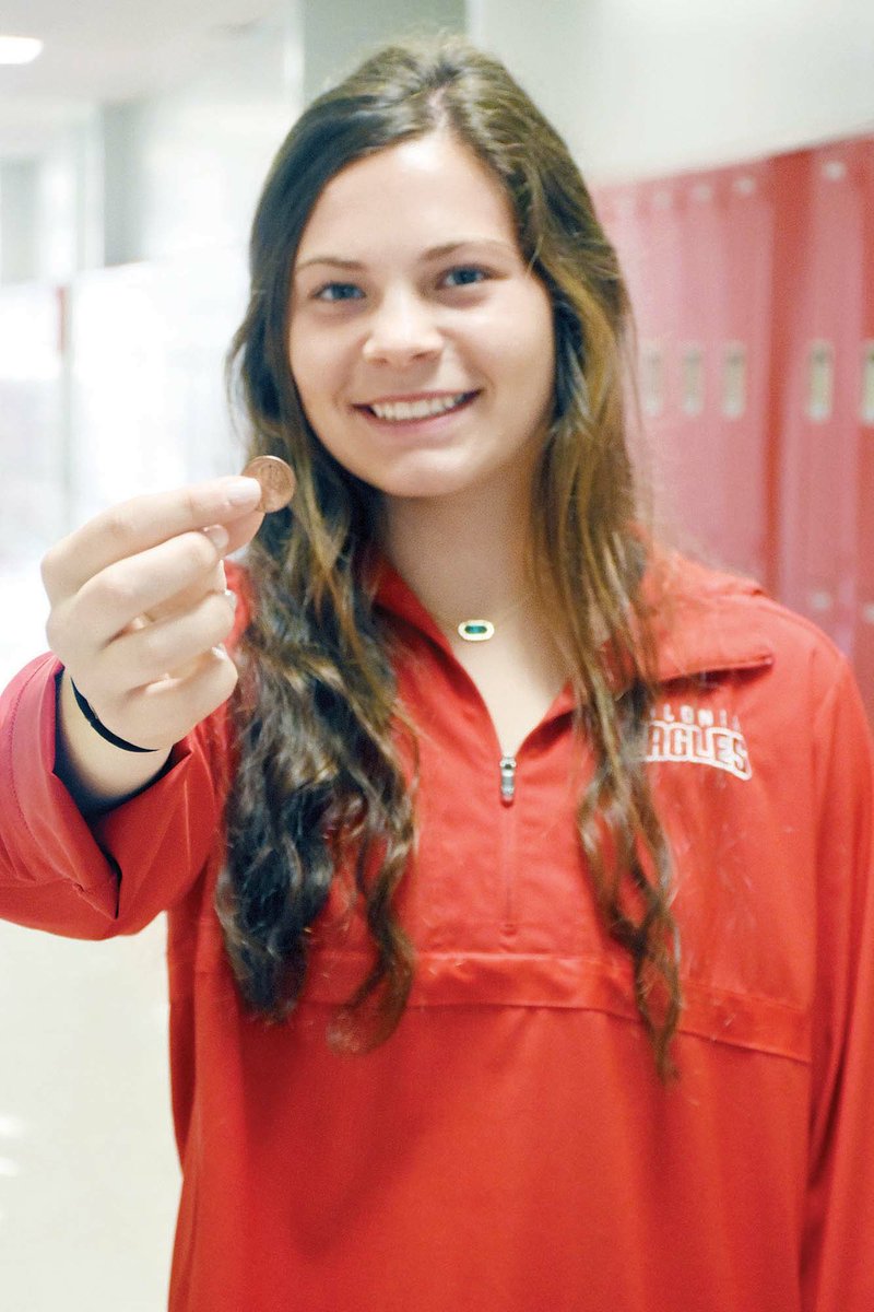 staci vandagriff/river valley & Ozark edition
Grace Shannon, a 10th-grader at Vilonia High School, holds a penny. When she was in seventh grade, it was her idea as a class project to start One Cent, One Life to collect 6 million pennies to represent the Jews killed during the Holocaust. Pennies are still being collected through middle school teacher Linda Knapp. The revised plan is to get 1.5 million pennies to represent the children who were killed and create a display at the Vilonia Museum of Veterans and Military History. Donations may be mailed to Linda Knapp, 49 Eagle St., Vilonia, AR 72013; or brought to the middle school.