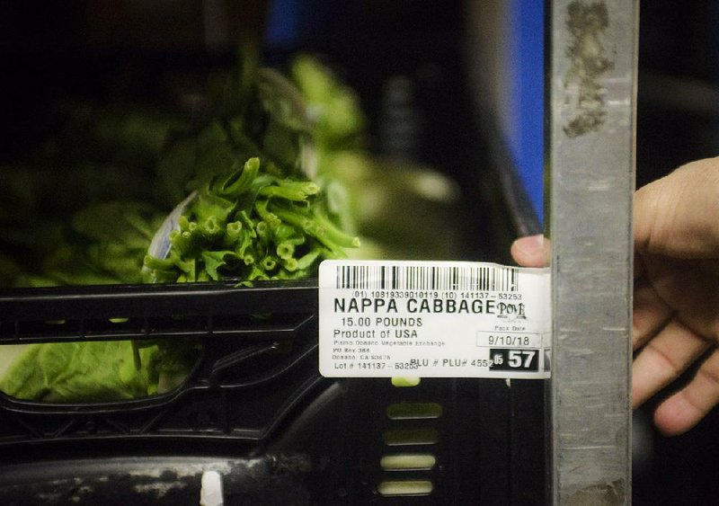 A tag at a Walmart store in Rogers describes the origin of a cabbage. Such tags are used in block- chain technology to help retailers track products.