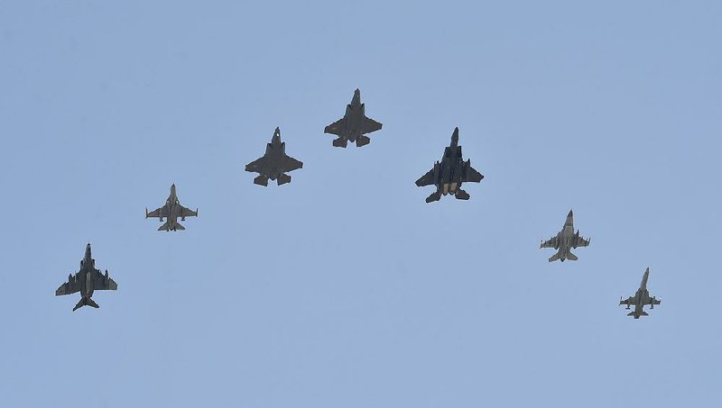 Two U.S. F-35A fighter jets (center and center left) fly Friday with South Korean fighter jets over Cheongju Air Base in South Korea. 