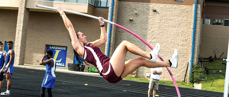 The Sentinel-Record/Grace Brown GOING UP: Lake Hamilton senior Edie Murray pulls herself up on her way over the bar in the pole vault Thursday afternoon at the Lakeside Ram Relays. Murray cleared 12 feet on the day to win the event.