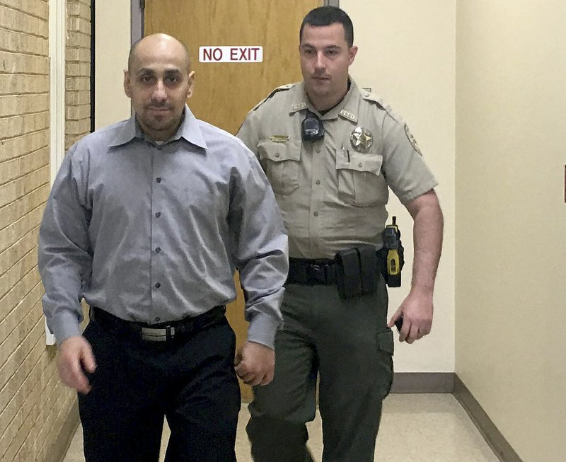 NWA Democrat-Gazette/TRACY NEAL
Oscar Perez of Rogers walks Thursday in the Benton County Courthouse while being escorted by a deputy.Perez was sentencedvto 200 years in prison for kidnapping and shooting a woman in the leg.