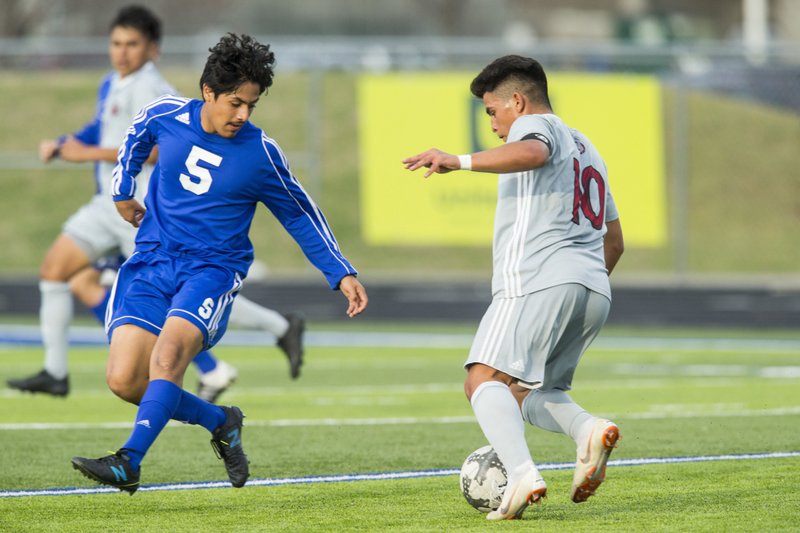 Ruben Ayala of Springdale heads the ball against Rogers on Friday during the match at Whitey Smith Stadium in Rogers.