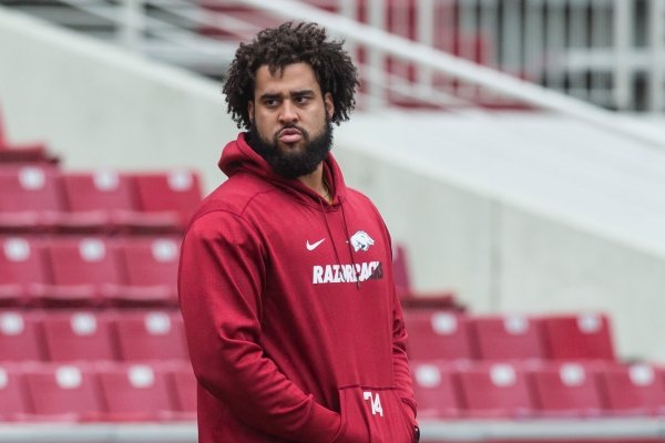 Colton Jackson, Arkansas offensive lineman, watches from the sidelines Saturday, March 30, 2019, during Arkansas spring practice at Reynolds Razorback Stadium in Fayetteville.