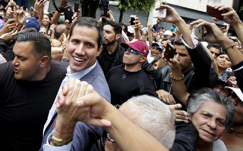 Venezuelan opposition leader Juan Guaido greets supporters Saturday in Los Teques in Venezuela’s Miranda state, one of several stops he made in the populous region. 