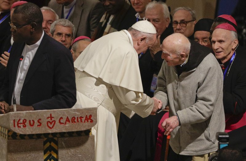 Pope Francis greets father Jean-Pierre Schumacher, a French monk who survived the Tibhirine killing, when seven Trappist monks and 12 other Catholics were kidnapped from the monastery of Tibhirine, south of Algiers in 1996 and killed, in the Rabat Cathedral, Morocco, Sunday, March 31, 2019. (AP Photo/Gregorio Borgia)