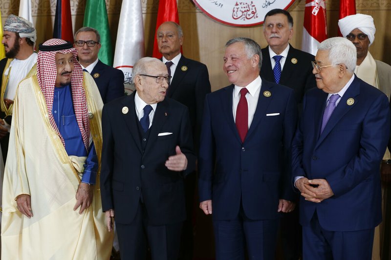 Tunisian President Beji Caid Essebsi, center left, stands with Saudi Arabia's King Salman bin Abdulaziz, left, Jordan's King Abdullah II, center right, and Palestinian President Mahmoud Abbas during the group photo with Arab leaders, ahead of the 30th Arab Summit in Tunis, Tunisia, Sunday, March 31, 2019. Leaders meeting in Tunisia for the annual Arab League summit on Sunday were united in their condemnation of Trump administration policies seen as unfairly biased toward Israel but divided on a host of other issues, including whether to readmit founding member Syria.