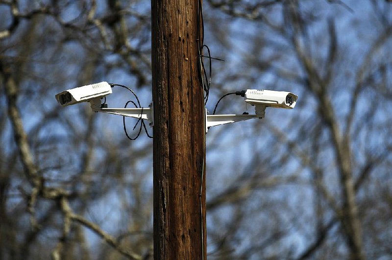 The two cameras that gather data for a license plate reader are seen last month on West 12th Street in Little Rock. 